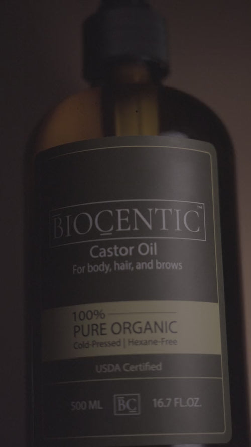 closeup shot of organic castor oil with 90 percent ricinoleic acid in a 16 fl oz glass bottle